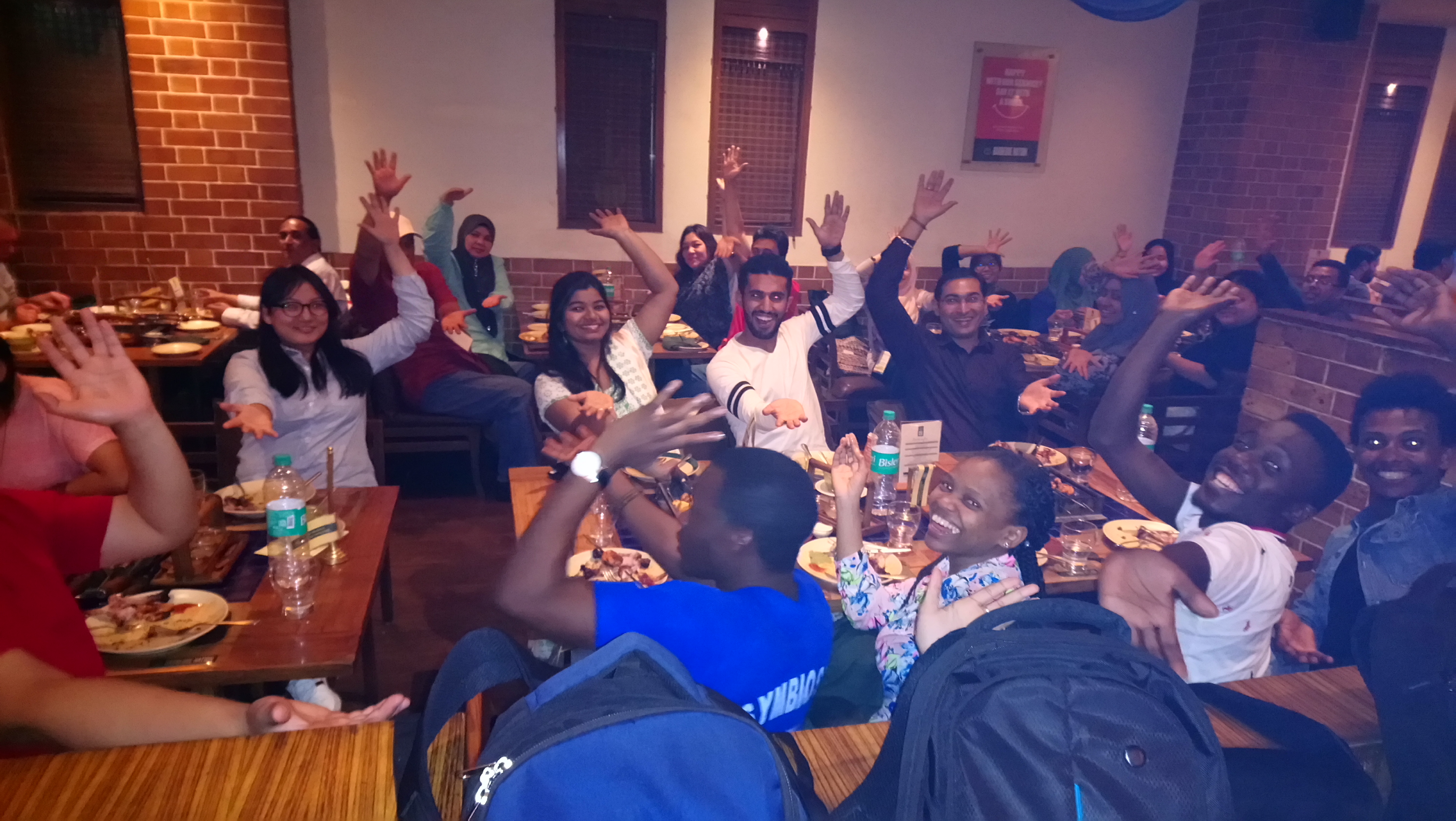 1st Innompic Games networking dinner hands up Innompics gesture